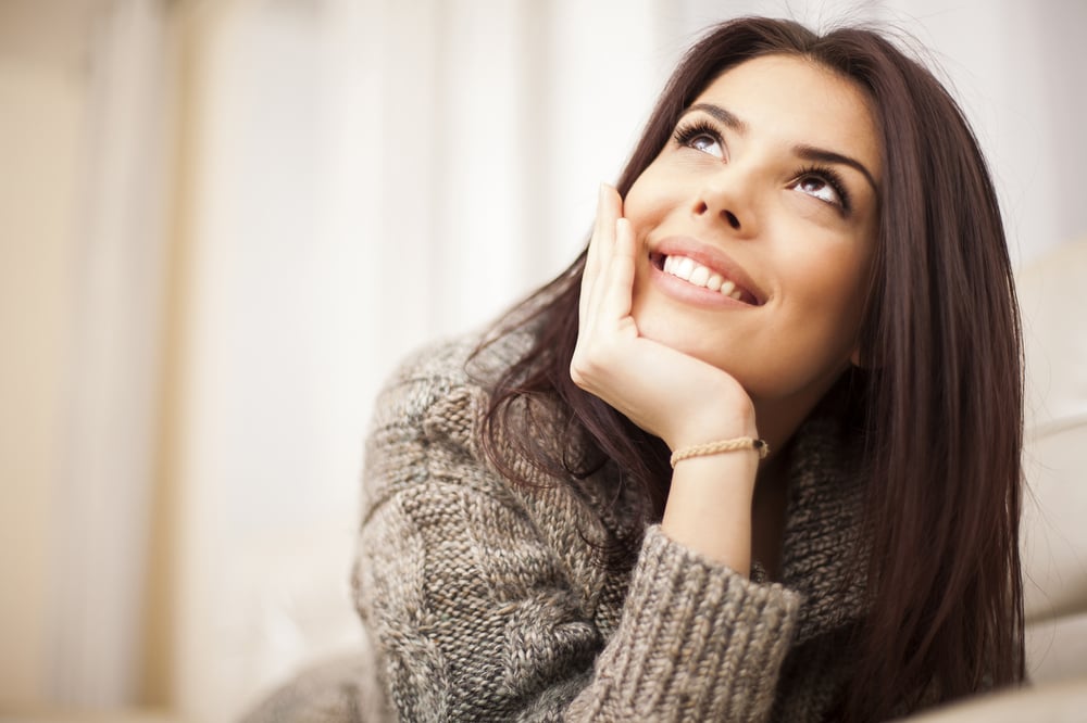 Closeup portrait of a Happy young beautiful woman relaxing at home